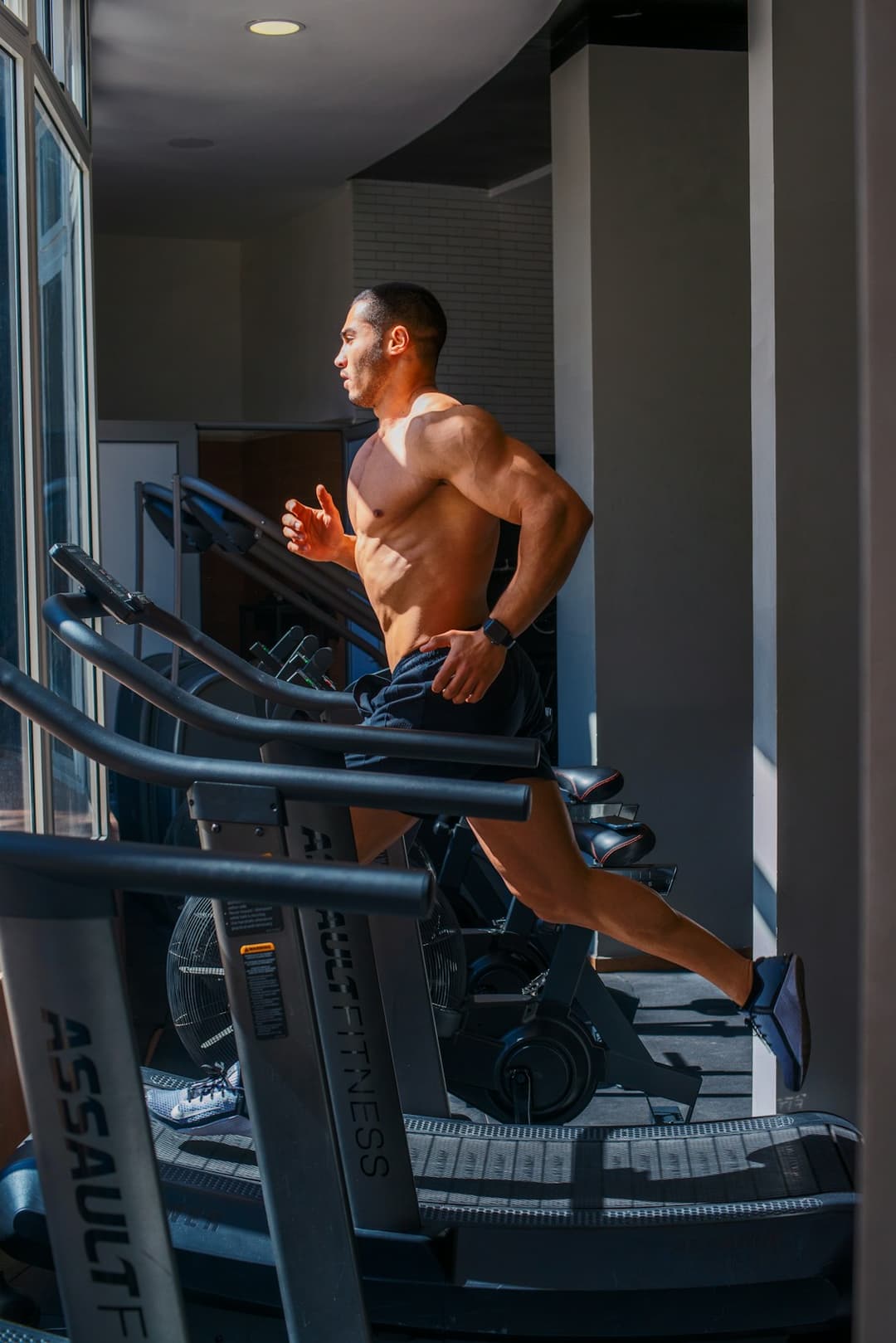 Person running on advanced gym equipment